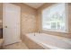 Relaxing bathroom with a jetted tub and tile surround at 4415 Ashford Pl, Douglasville, GA 30135