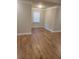 Bright bedroom featuring hardwood floors and a window with blinds at 4430 Vernon Nw St, Lilburn, GA 30047