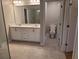 Bathroom with double vanity, tile floor, and a separate toilet area at 4430 Vernon Nw St, Lilburn, GA 30047