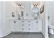 Bathroom with double vanity, white cabinets, and black hardware at 1170 Upper Sweetwater Se Trl, White, GA 30184