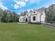 White farmhouse exterior with gray roof, front porch, and landscaping at 1170 Upper Sweetwater Se Trl, White, GA 30184