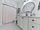 Bathroom with a pink shower curtain and hexagon tile floor at 1170 Upper Sweetwater Se Trl, White, GA 30184