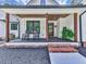 Inviting front porch with rocking chairs and brick steps at 1170 Upper Sweetwater Se Trl, White, GA 30184