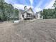 Rear view of house showcasing a large deck and wooded setting at 1170 Upper Sweetwater Se Trl, White, GA 30184