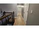 Bright hallway with wood-look flooring and staircase at 909 Pin Oak Pl, Canton, GA 30115