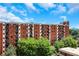 Brick apartment building with balconies and lush landscaping at 300 Johnson Ferry Ne Rd # B904, Atlanta, GA 30328