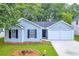 Newly built home with gray siding, two-car garage, and a well-maintained lawn at 4084 Waldrop Hills Dr, Decatur, GA 30034