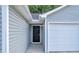 Side entrance to the house and garage with gray siding and black door at 4084 Waldrop Hills Dr, Decatur, GA 30034