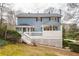 Two-story house with blue siding, deck, and surrounding trees at 2990 Mountain Ne Trce, Roswell, GA 30075