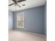 Light blue bedroom with a ceiling fan and large window at 2990 Mountain Ne Trce, Roswell, GA 30075