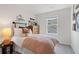 Cozy bedroom with a queen-size bed, dresser, and large window at 77 Werner Brook Way, Atlanta, GA 30354