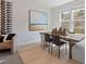 Bright dining room with wood table, four chairs, and wine bottle display at 77 Werner Brook Way, Atlanta, GA 30354