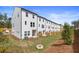 Rear view of townhomes with fenced yards and a fire pit at 77 Werner Brook Way, Atlanta, GA 30354