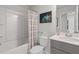 Clean bathroom with a tub shower combo, gray vanity, and a toilet at 77 Werner Brook Way, Atlanta, GA 30354