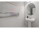 Small powder room with pedestal sink and framed art at 77 Werner Brook Way, Atlanta, GA 30354