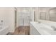 Spa-like bathroom with double vanity, shower, and tile floors at 305 Silver Moon Dr, Loganville, GA 30052