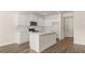 Modern kitchen with white cabinets and a large island at 305 Silver Moon Dr, Loganville, GA 30052