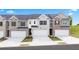 Three townhouses with attached garages and landscaping at 305 Silver Moon Dr, Loganville, GA 30052