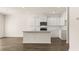 Modern kitchen with white cabinets and quartz countertops at 305 Silver Moon Dr, Loganville, GA 30052