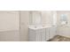 Double vanity bathroom with tile flooring and plenty of storage at 305 Silver Moon Dr, Loganville, GA 30052