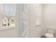 Clean and bright bathroom with toilet and window at 305 Silver Moon Dr, Loganville, GA 30052