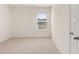 Well-lit bedroom featuring a window and neutral decor at 305 Silver Moon Dr, Loganville, GA 30052
