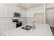 Modern kitchen with island and stainless steel appliances at 305 Silver Moon Dr, Loganville, GA 30052