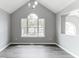 Dining room featuring a vaulted ceiling, large window, and grey walls at 5452 Sweetsprings, Powder Springs, GA 30127