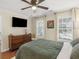 Comfortable bedroom featuring hardwood floors and a dresser at 144 Wyckliffe Dr, Locust Grove, GA 30248