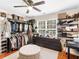 Well-organized closet with shelves, hanging rods, and vanity area at 144 Wyckliffe Dr, Locust Grove, GA 30248