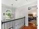 Upper level hallway with arched window and view into bedroom at 144 Wyckliffe Dr, Locust Grove, GA 30248