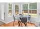 Kitchen breakfast area with glass table and chairs, overlooking backyard at 144 Wyckliffe Dr, Locust Grove, GA 30248