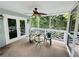 Relaxing screened porch with ceiling fan, comfy seating, and wooded views at 2606 Ramblewood Ct, Acworth, GA 30102