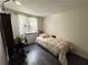 Bright bedroom with a twin bed, window, and wood-look flooring at 2606 Ramblewood Ct, Acworth, GA 30102