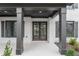 Covered front porch entry with dark brown double doors at 2899 Treeside Terrace, Marietta, GA 30066