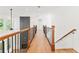 Upstairs hallway with hardwood floors, wooden railings, and fireplace view at 2899 Treeside Terrace, Marietta, GA 30066