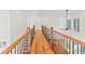 Upstairs hallway with hardwood floors and wooden railings at 2899 Treeside Terrace, Marietta, GA 30066