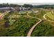 Long wooden boardwalk winding through green space and a mixed-use development at 630 Skytop Dr # 157, Cumming, GA 30040