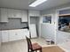 Simple, unfinished kitchen with white cabinets and gray walls at 6225 Collins Nw Rd, Acworth, GA 30101