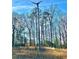 Wooded lot with a wind turbine and open field at 6225 Collins Nw Rd, Acworth, GA 30101