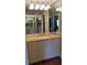 Bathroom with granite countertops, double sinks, and mirrored walls at 6225 Collins Nw Rd, Acworth, GA 30101