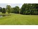 Property with pond and lush green landscape at 6225 Collins Nw Rd, Acworth, GA 30101