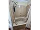 Bathroom with a tub and shower, featuring updated fixtures at 6225 Collins Nw Rd, Acworth, GA 30101