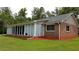 Brick home with sunroom and landscaping at 6225 Collins Nw Rd, Acworth, GA 30101