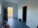 Empty interior room with light blue walls and blue floor at 6225 Collins Nw Rd, Acworth, GA 30101