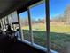 Enjoy the view from the screened porch overlooking a pond and lush landscape at 6225 Collins Nw Rd, Acworth, GA 30101