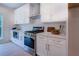 Modern kitchen with white cabinets, stainless steel appliances, and quartz countertops at 160 Rose Creek Dr, Covington, GA 30014