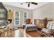 Bedroom with hardwood floors, ceiling fan, and dresser at 5833 Wind Haven Nw Ct, Kennesaw, GA 30152