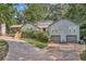 Gray two-story house with double garage, landscaped yard and a long driveway at 5833 Wind Haven Nw Ct, Kennesaw, GA 30152