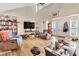 Spacious living room with hardwood floors, vaulted ceiling, and large windows at 5833 Wind Haven Nw Ct, Kennesaw, GA 30152